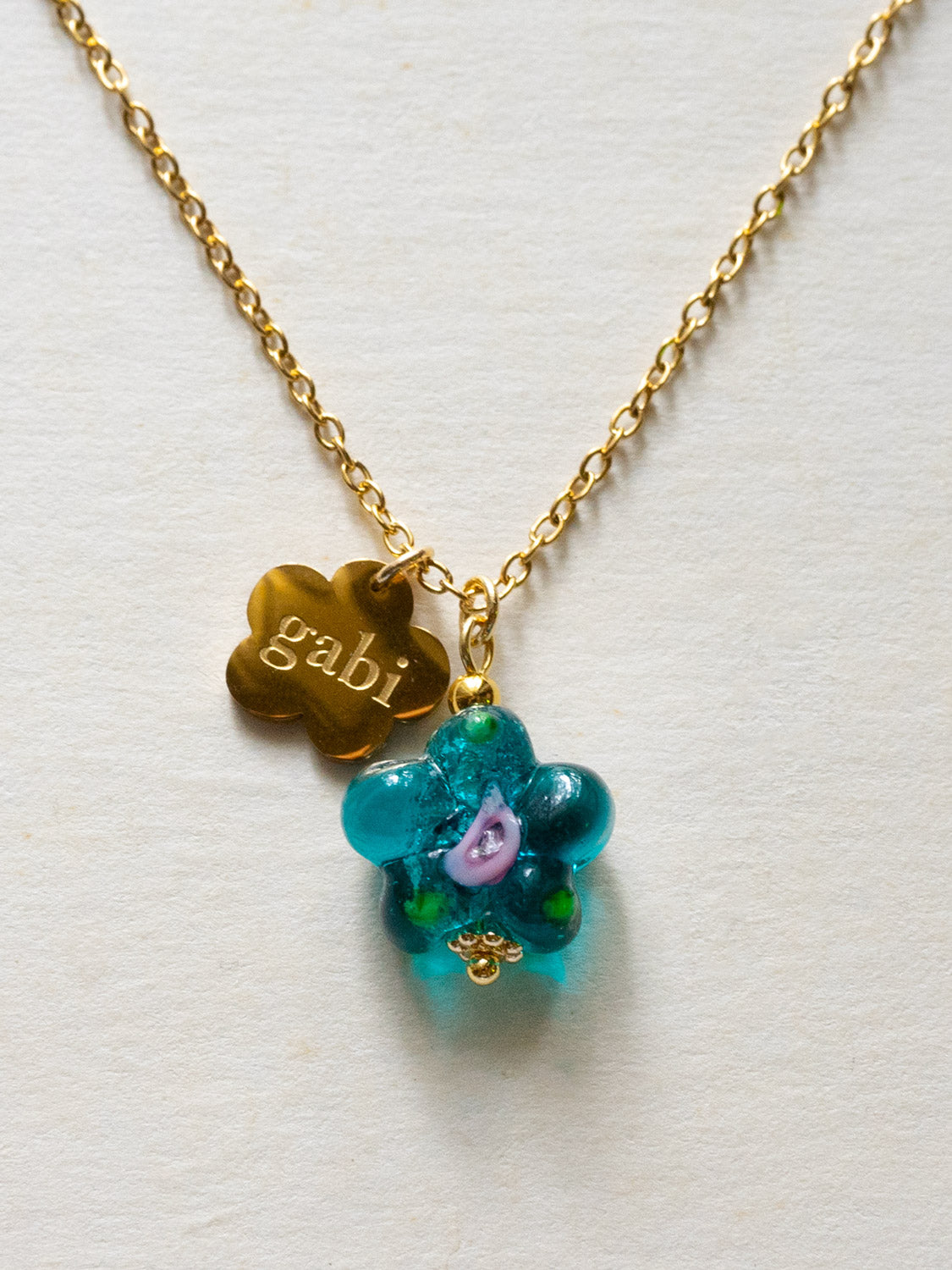 Gold Gabi Charm Necklace  Stainless Steel   Teal Green Glass Flower2 c14eb547 c3da 41b6 b8b1 7371493ae305