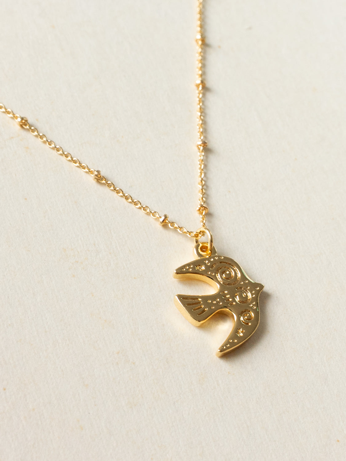 Resort Necklace, Gold - Carved Peaceful Dove