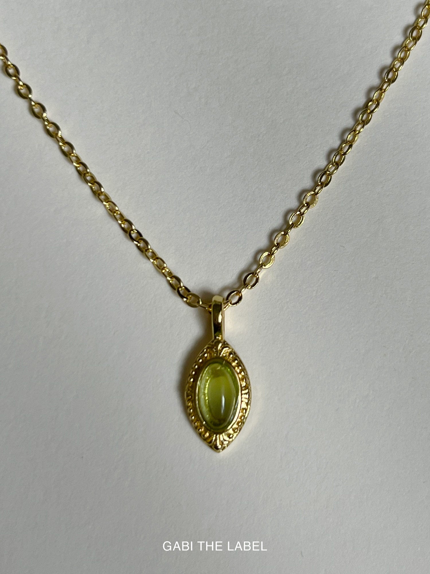 green pendant necklace logo
